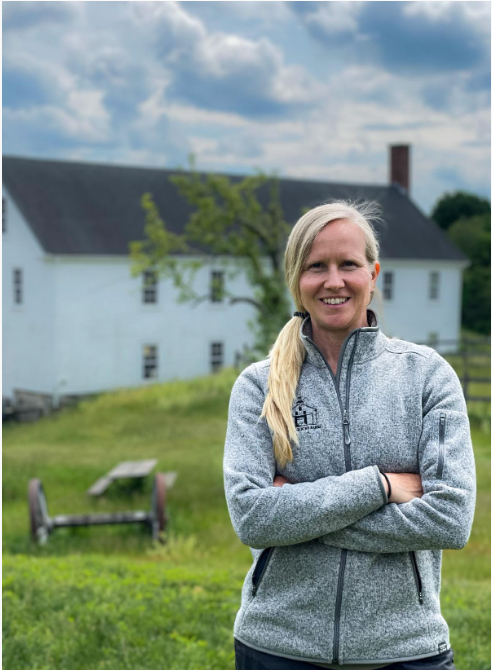 Erika Gorgenyi - new executive director of Wright-Locke Farm - in front of the Squash Barn.